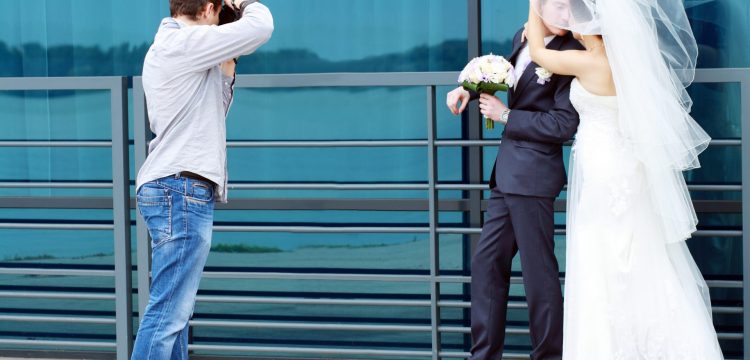 Photographer taking a picture of a wedded couple.