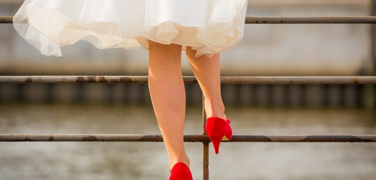 Bride in tea length dress with red heels.