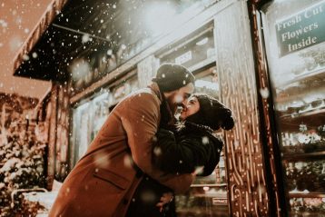Man and woman embracing in the snow.