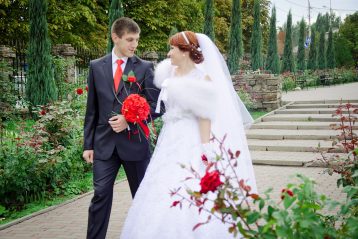 Bride and groom holding hands.