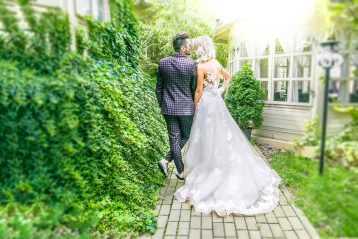 Bride and groom walking down a path.