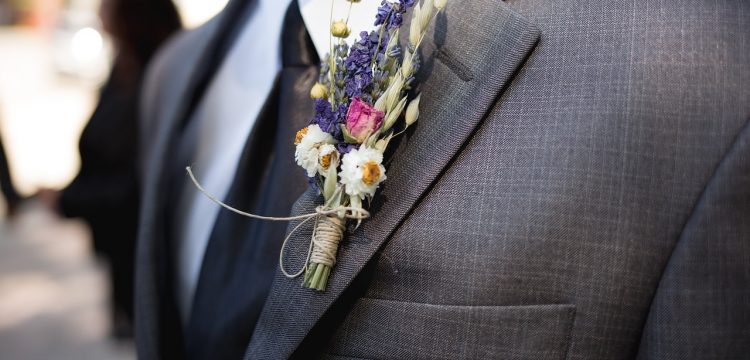 A groom wearing a bouttoniere.