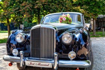 A retro car with a Just Married sign on the front.