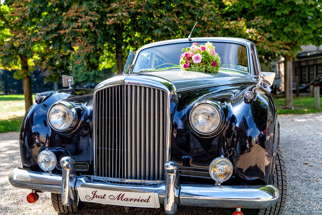 A retro car with a Just Married sign on the front.