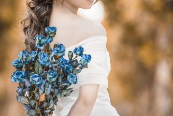 Bride holding a blue bouquet.