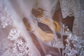 Wedding shoes and the tulle of a wedding gown.
