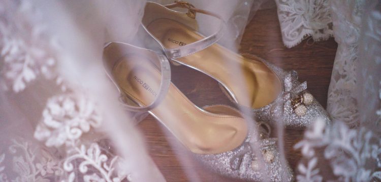 Wedding shoes and the tulle of a wedding gown.