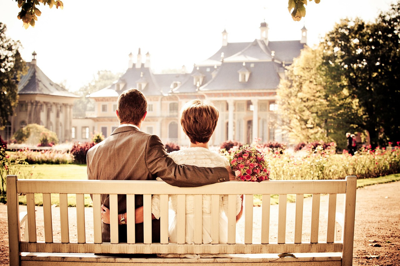 Bride and groom on a bench.