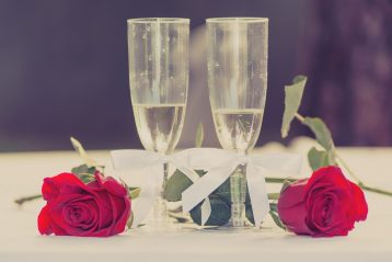 Champagne glasses and red roses.