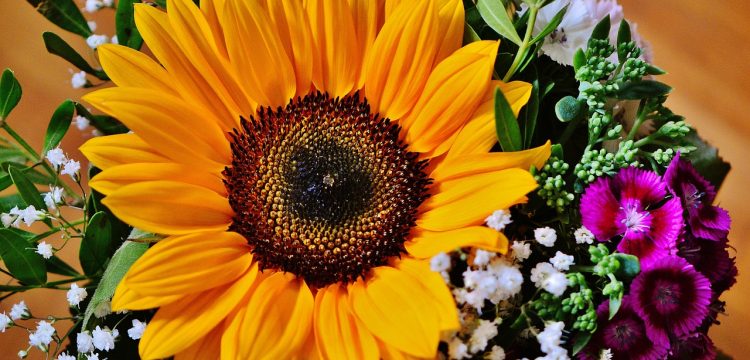 A bouquet with a large sunflower in the center.
