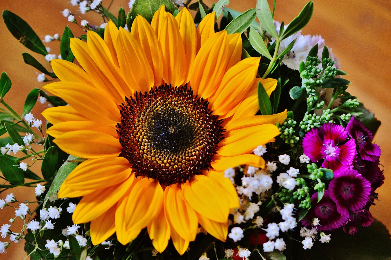 A bouquet with a large sunflower in the center.