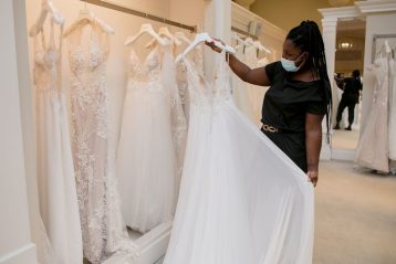 Woman looking at a wedding gown in a dress shop