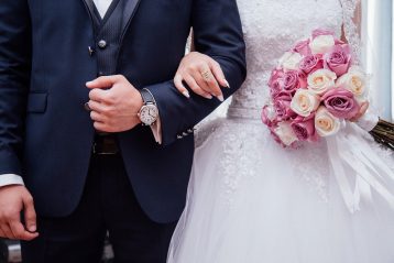 Bride and groom with linked arms.