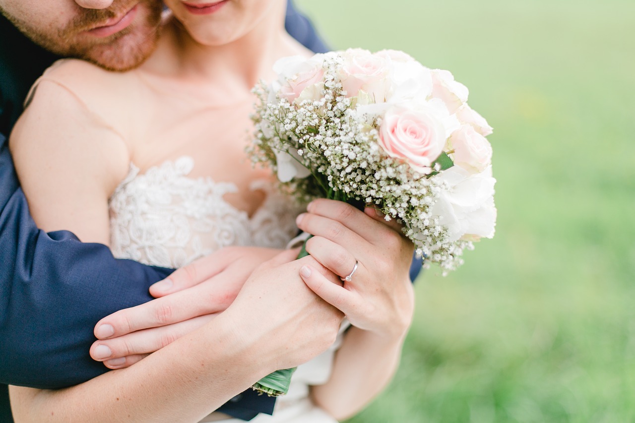 Bride and groom hugging.