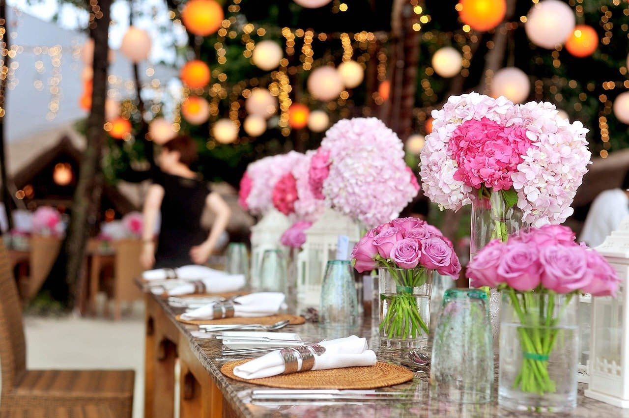 Wedding reception table with pink centerpieces.