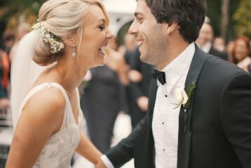 Bride and groom laughing.