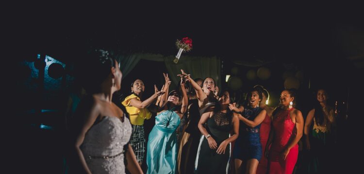 Bride tossing bouquet to guests.