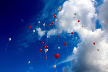 Heart balloons floating in the sky.