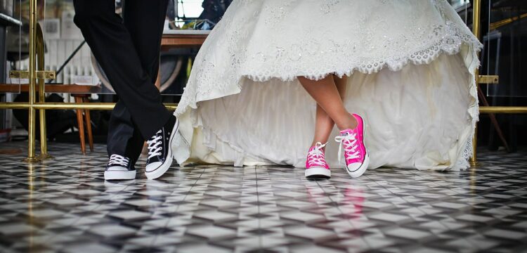 Bride and groom wearing sneakers.
