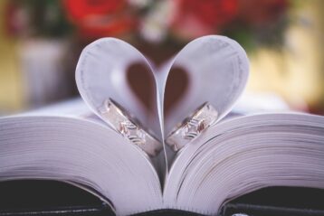Wedding rings in the pages of a Bible.
