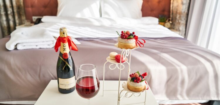 Upscale hotel room with champagne on a table.