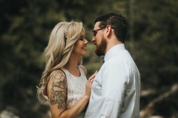 Couple with tattoos embracing.
